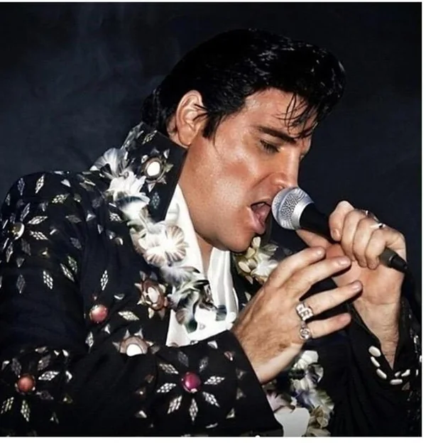 Elvis tribute act JC Aron performing in a jewelled jacket