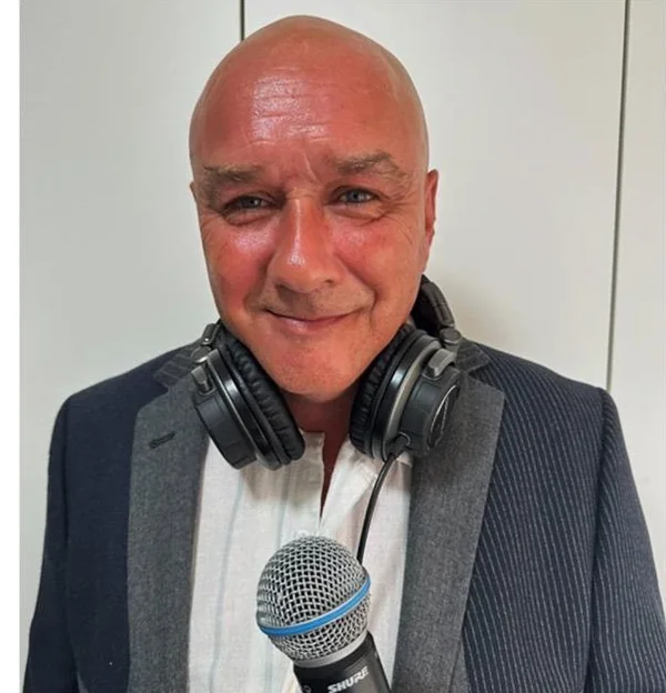 DJ Ronnie-O with headphones and a microphone