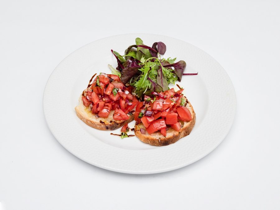 Bruschetta topped with tomato, basil and mozzarella
