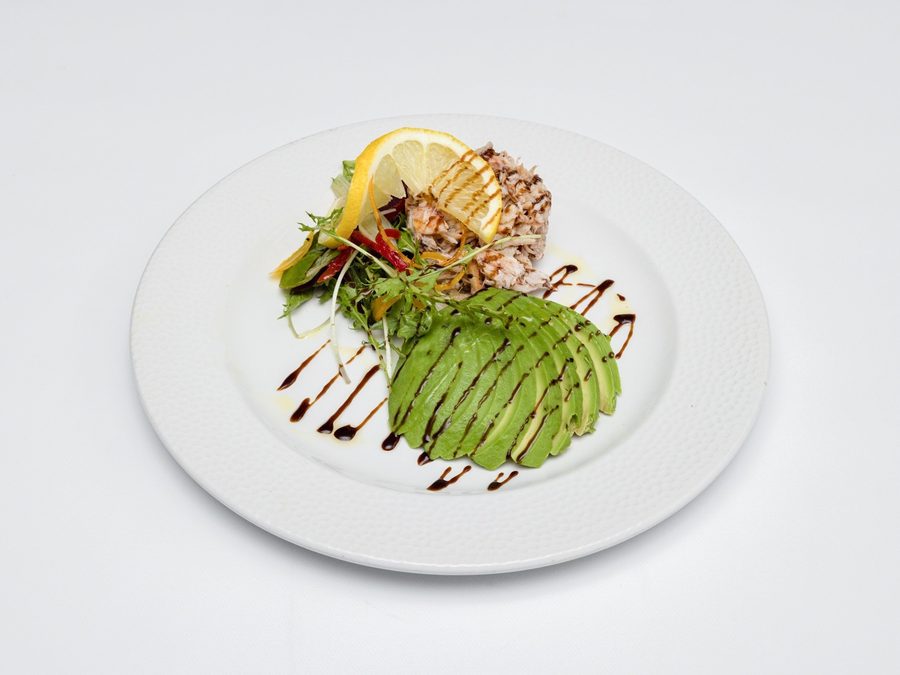 Smashed avocado topped with crab meat and microgreens